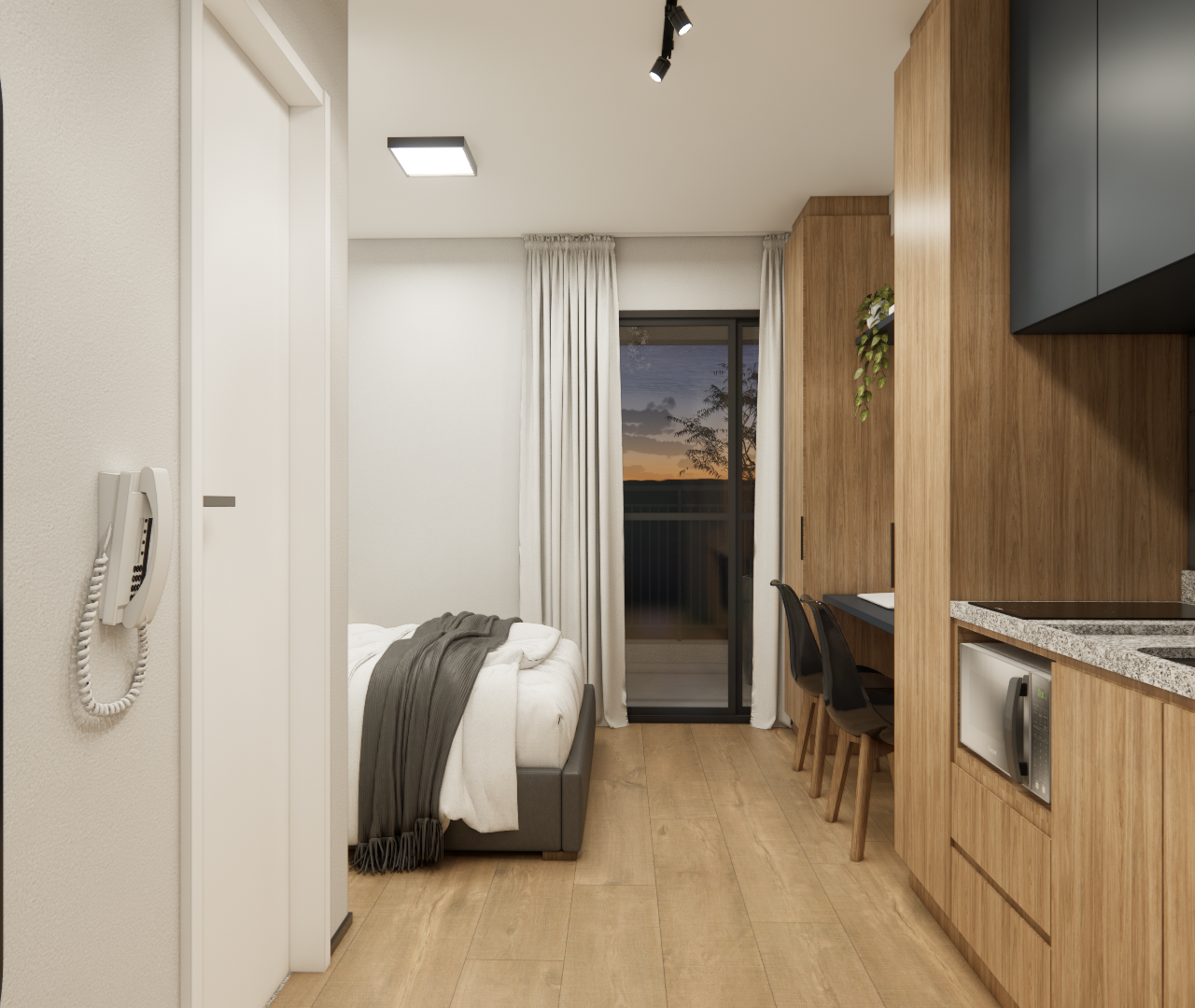 Cozinha amadeirada com armários superiores escuros, geladeira prateada e televisão voltada para a cama no ambiente integrado.